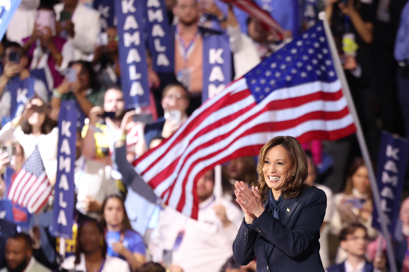U.S. Vice President and 2024 Democratic presidential candidate Kamala Harris waves as she leaves the stage on the fourth and last day of the Democratic National Convention (DNC) at the United Center in Chicago, Illinois, on August 22, 2024. (CHARLY TRIBALLEAU/AFP via Getty Images)