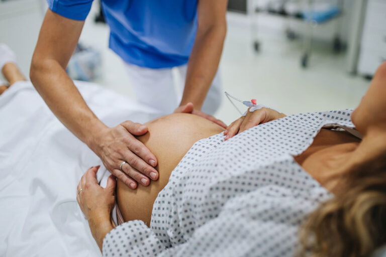 Obstetrician examining pregnant woman in hospital (Getty Images/Halfpoint Images)
