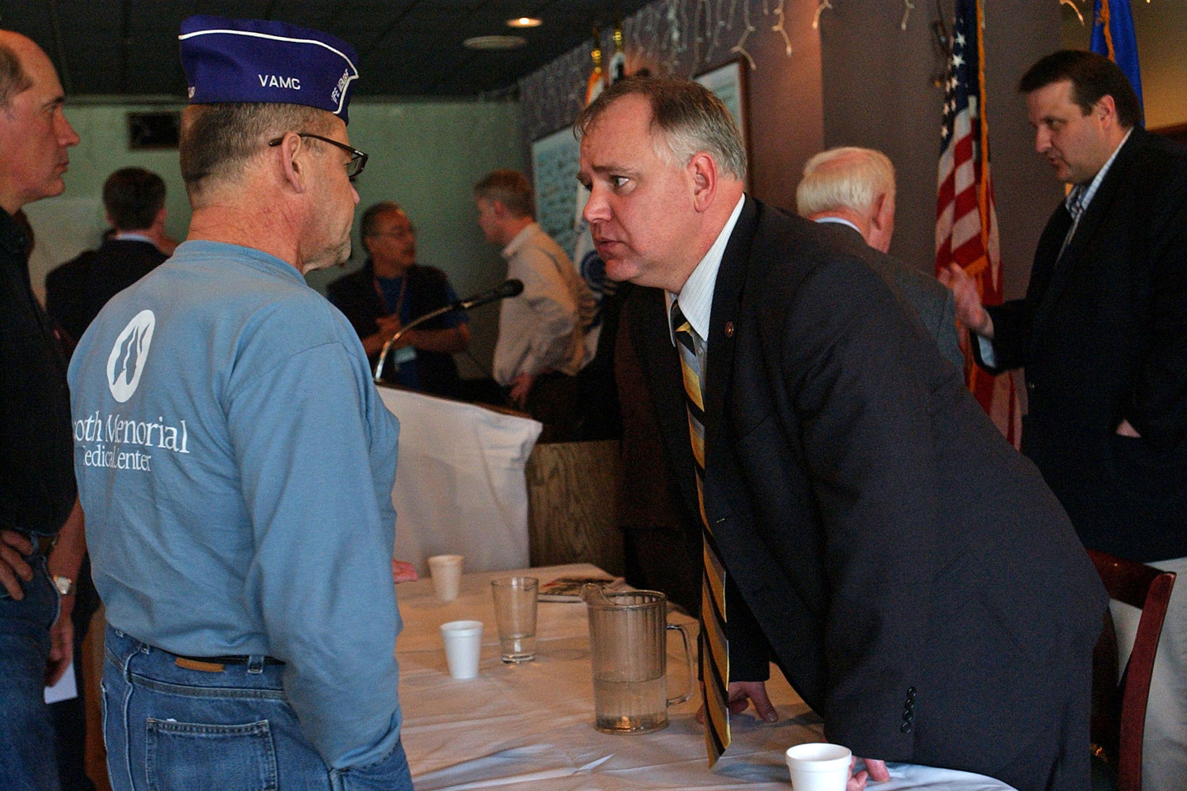 Dan Grambart, a member of the Military Order of the Purple Heart, talked with Rep. Tim Walz after the town meeting about veteran's issues held at the Richfield VFW. (Joey McLeister/Star Tribune via Getty Images)