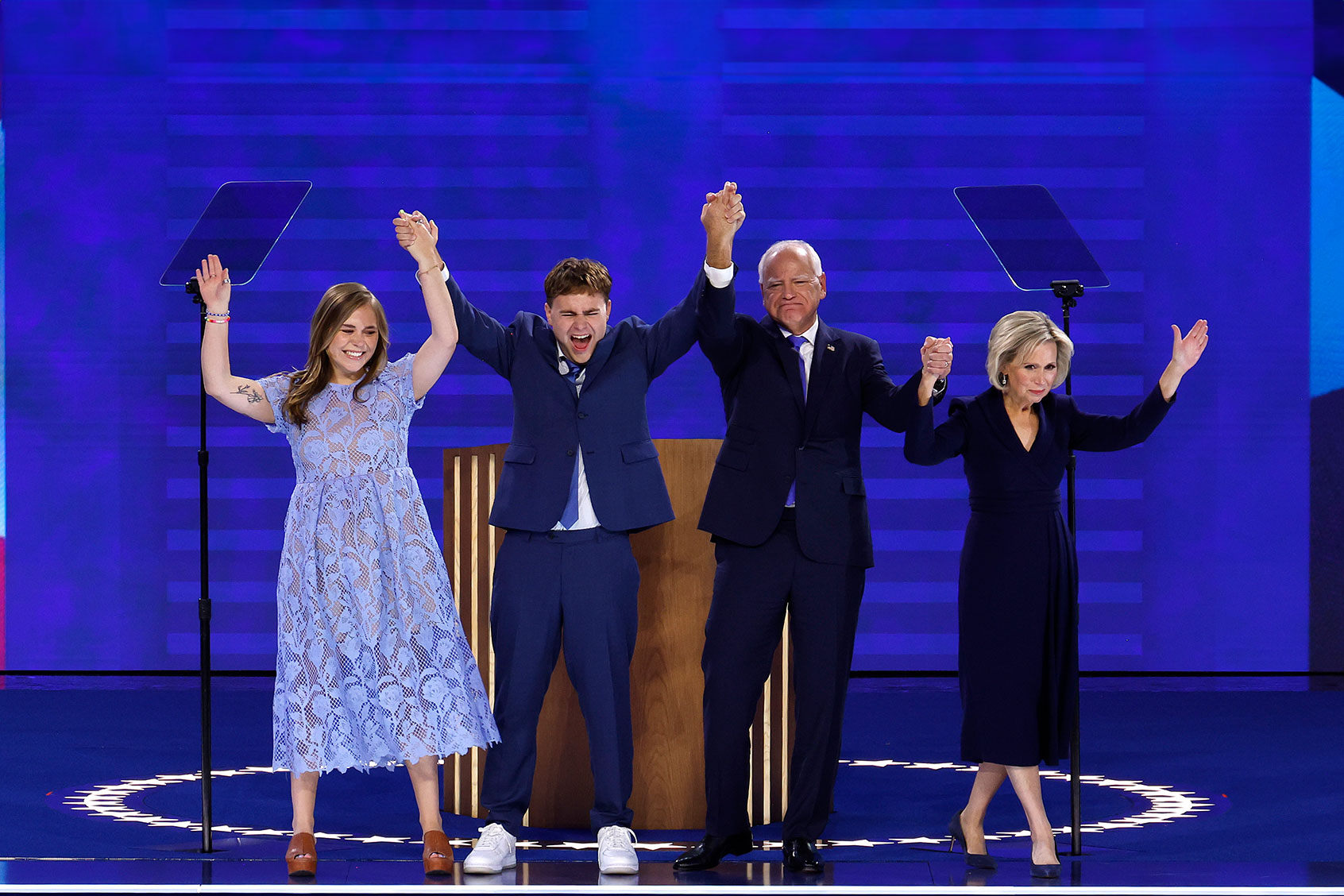 Democratic vice presidential nominee Minnesota Gov. Tim Walz celebrates with his daughter Hope Walz (L), son Gus Walz (2nd-L) and wife Gwen Walz (R) after accepting the Democratic vice presidential nomination on stage during the third day of the Democratic National Convention at the United Center on August 21, 2024 in Chicago, Illinois. (Chip Somodevilla/Getty Images)