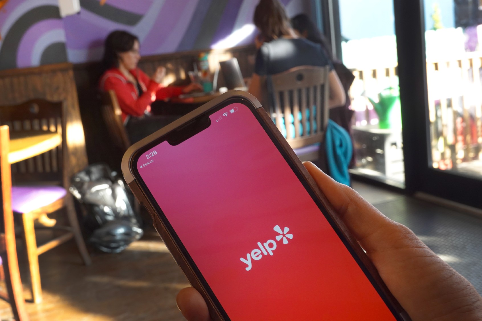 A Yelp splash page is displayed on a cell phone on November 14, 2023 in Chicago, Illinois. (Photo Illustration by Scott Olson/Getty Images)