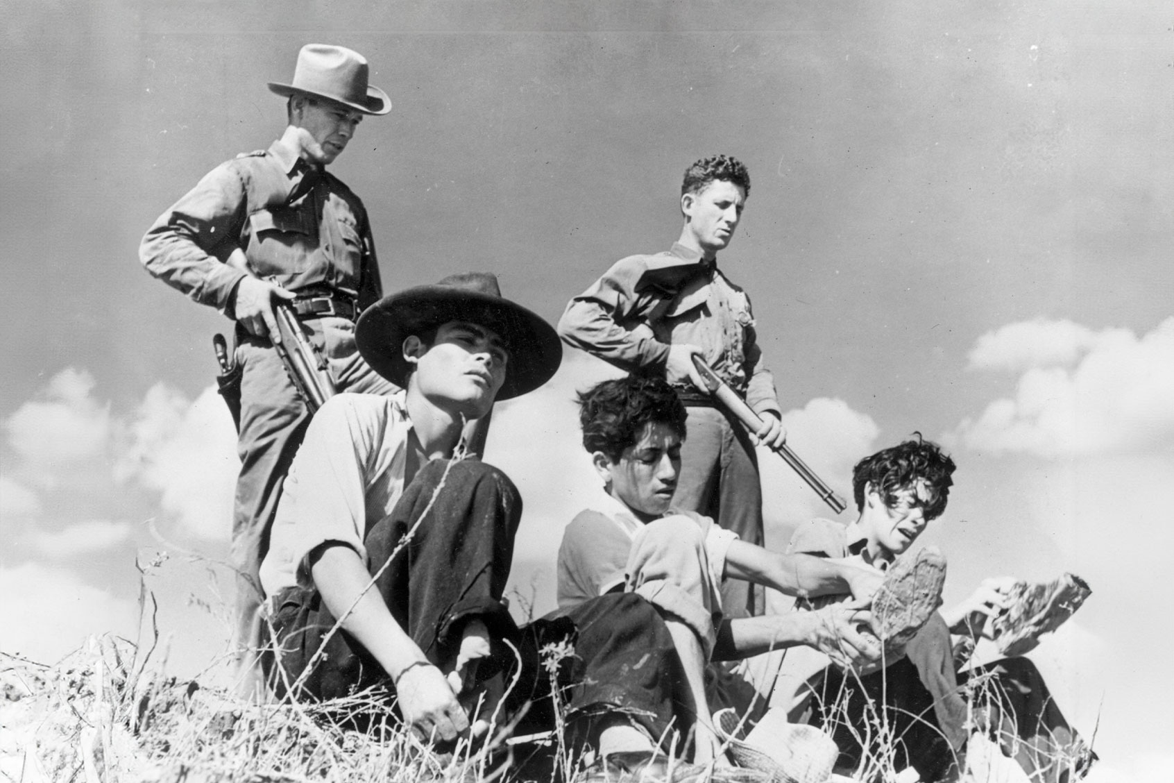 June 1948: Members of the Texas Border Patrol guarding illegal Mexican immigrants captured close to the Mexican border. (Harry Pennington/Keystone Features/Getty Images)