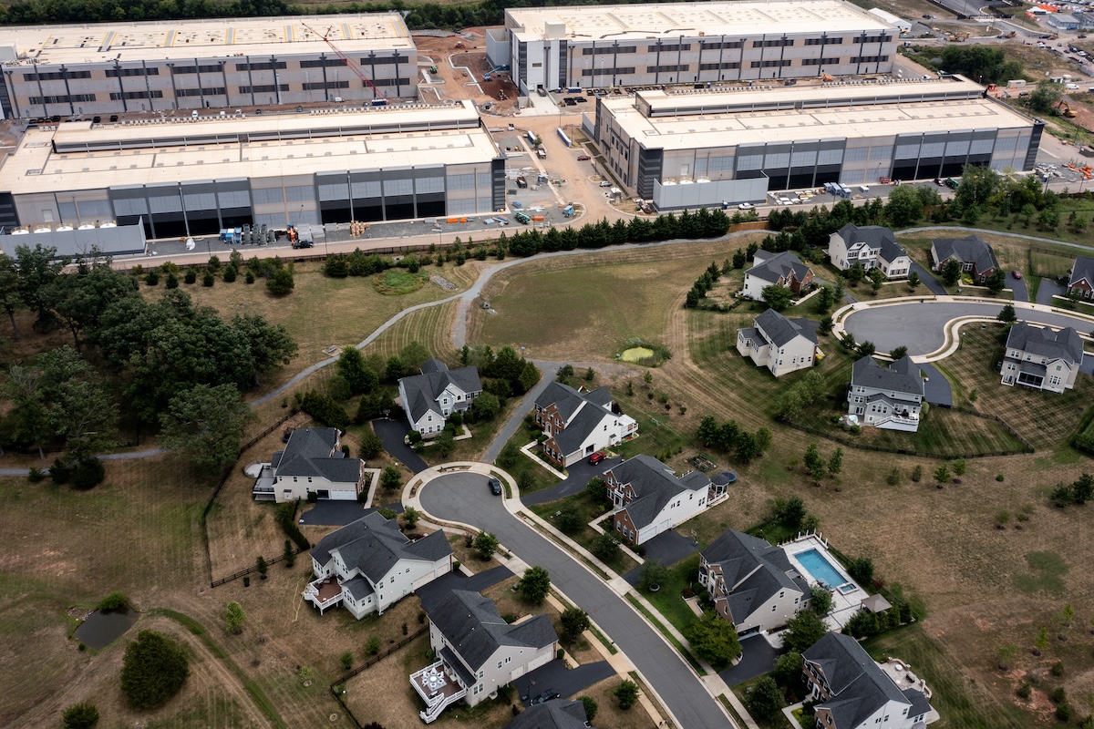 STONE RIDGE, VIRGINIA - JULY 17: In an aerial view, an Amazon Web Services data center is shown situated near single-family homes on July 17, 2024 in Stone Ridge, Virginia. Northern Virginia is the largest data center market in the world, according to a report this year cited in published accounts, but is facing headwinds from availability of land and electric power. ((Photo by Nathan Howard/Getty Images))