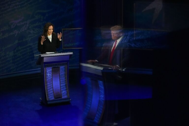 Former President and Republican presidential candidate Donald Trump, reflected on a wall, and Vice President and Democratic presidential candidate Kamala Harris during the first presidential debate at National Constitution Center in Philadelphia, PA on Tuesday, Sept. 10, 2024. (Demetrius Freeman/The Washington Post via Getty Images)