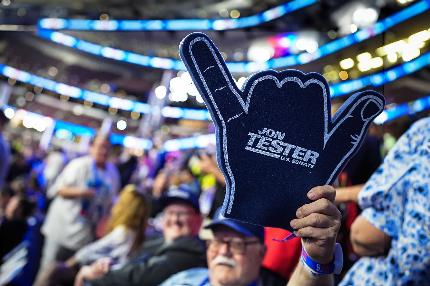 An attendee holds up sign supporting U.S. Sen. Jon Tester (D-MT) during the second day of the Democratic National Convention at the United Center on August 20, 2024 in Chicago, Illinois. (Andrew Harnik/Getty Images)