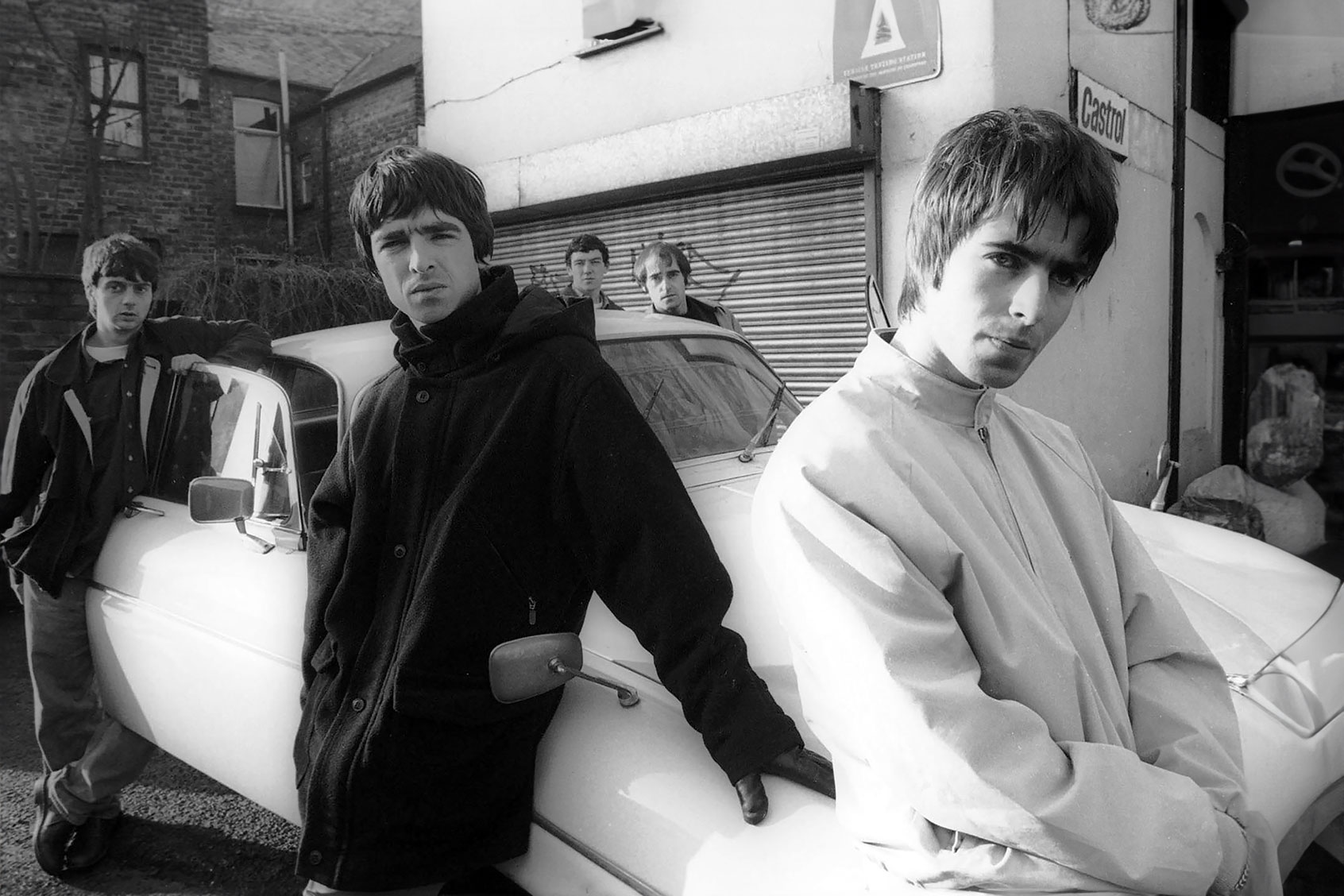 Portrait of British rock band Oasis leaning against a Jaguar XJ6 car in Withington, Manchester, United Kingdom, 30th November 1993. (James Fry/Getty Images)