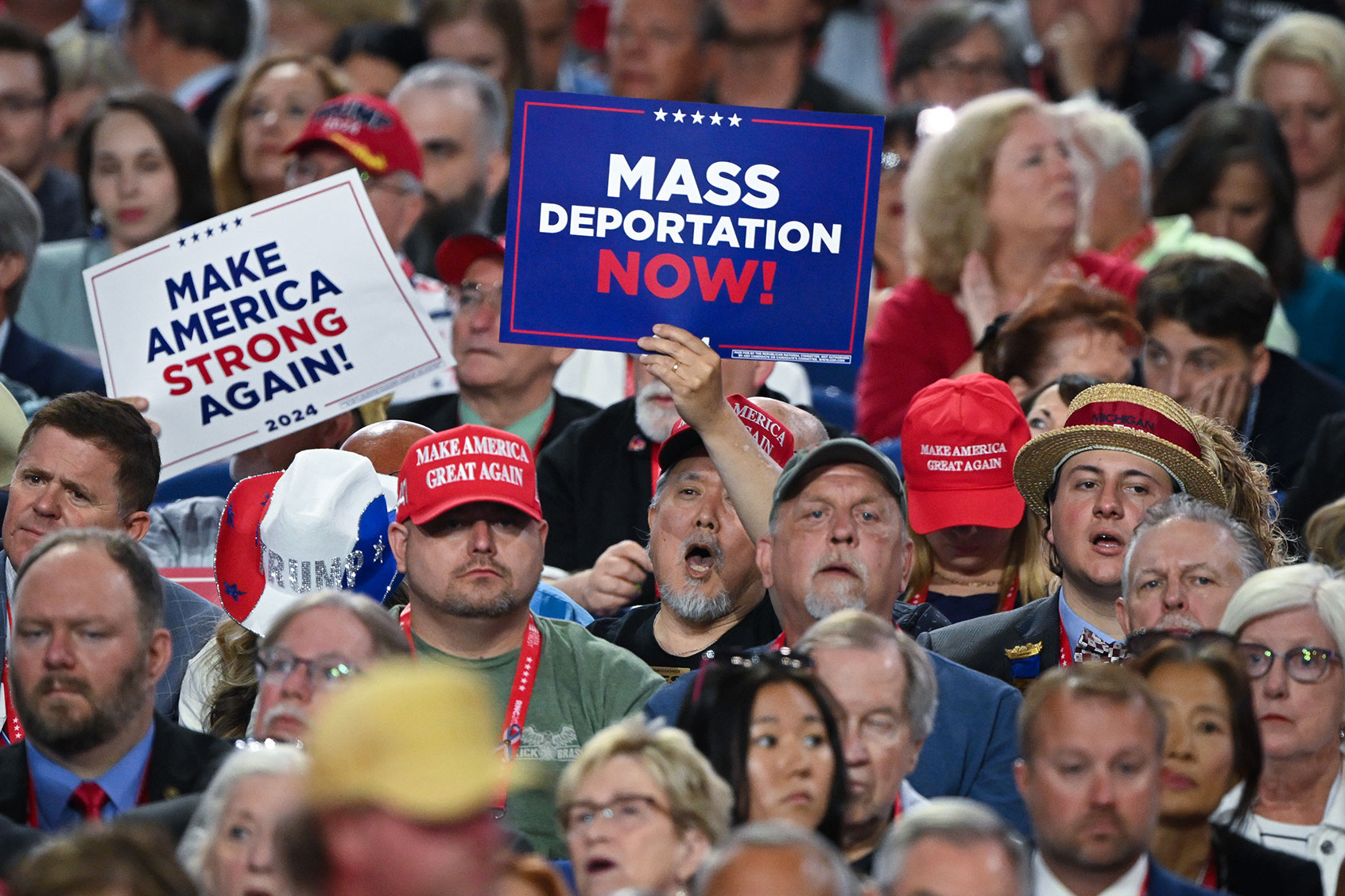 A person holds a sign that reads "Mass Deportation Now" and "Make America Strong Again" on the third day of the Republican National Convention at the Fiserv Forum on July 17, 2024 in Milwaukee, Wisconsin. (Leon Neal/Getty Images)