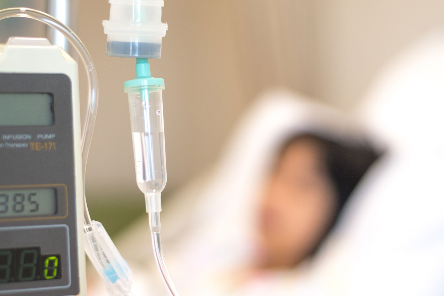 Child patient with IV line in hospital bed (Getty Images/Pornpak Khunatorn)