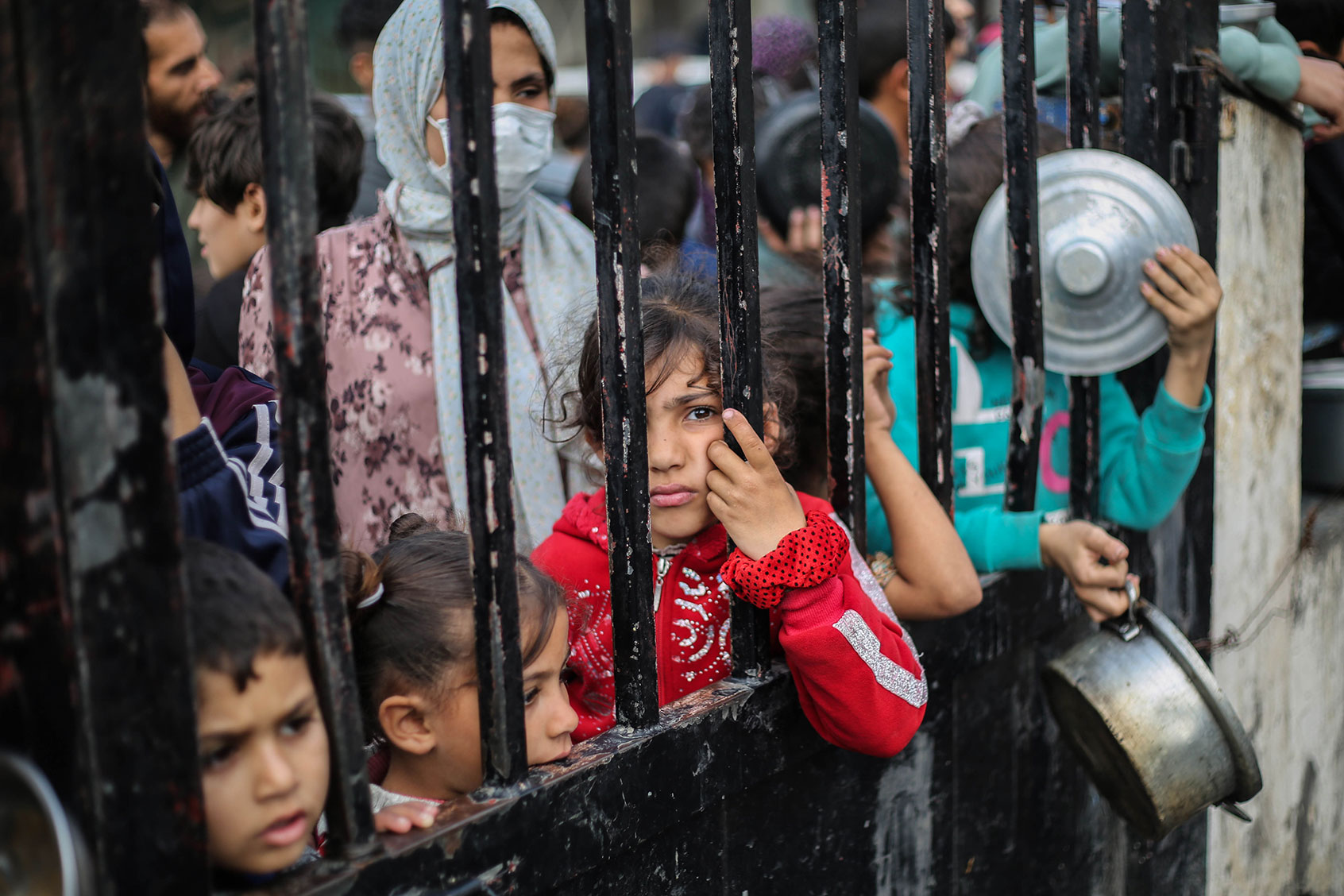 Citizens queue for food that is cooked in large pots and distributed for free during war-time on December 28, 2023 in Rafah, Gaza. (Ahmad Hasaballah/Getty Images)