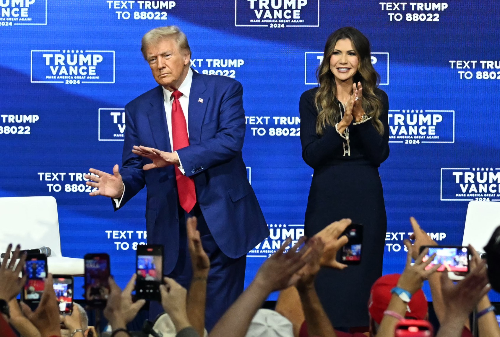 Former President and Republican presidential candidate Donald Trump, with moderator and South Dakota Governor Kristi Noem (R), at a town hall at the Greater Philadelphia Expo Center and Fairgrounds in Oaks, Pennsylvania, on October 14, 2024. (JIM WATSON/AFP via Getty Images)