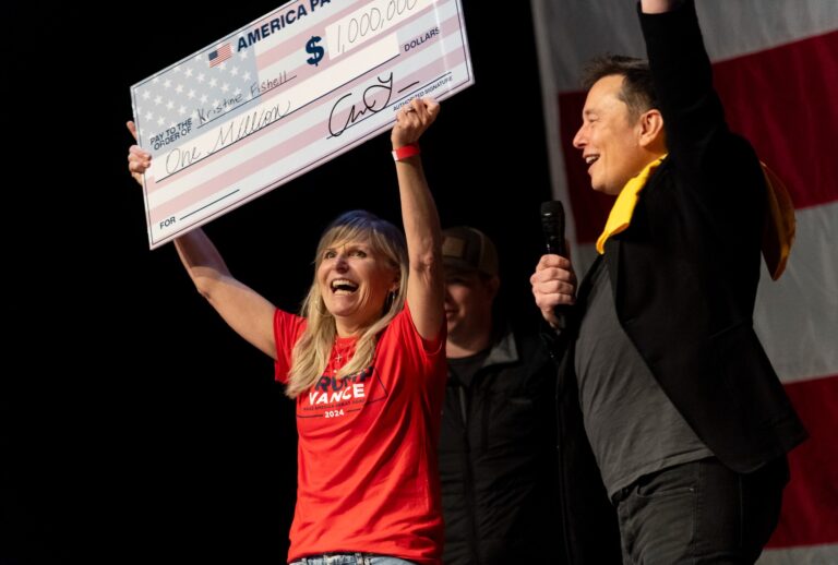 SpaceX and Tesla founder Elon Musk awarded Kristine Fishell with a $1 million check during the town hall at the Roxain Theater on October 20, 2024 in Pittsburgh, Pennsylvania. (Michael Swensen/Getty Images)