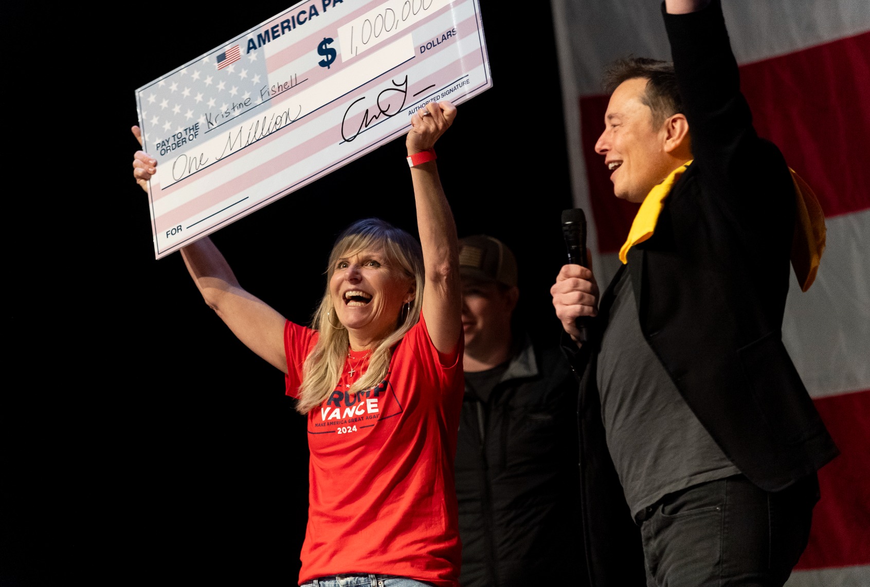 SpaceX and Tesla founder Elon Musk awarded Kristine Fishell with a $1 million check during the town hall at the Roxain Theater on October 20, 2024 in Pittsburgh, Pennsylvania. (Michael Swensen/Getty Images)