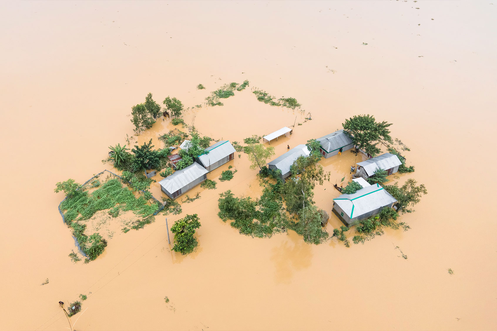 Heavy rains and water from upstream India submerge homes in a village in Jhenaigati upazila of Sherpur district, Bangladesh, on October 5, 2024. (Muhammad Amdad Hossain/NurPhoto via Getty Images)