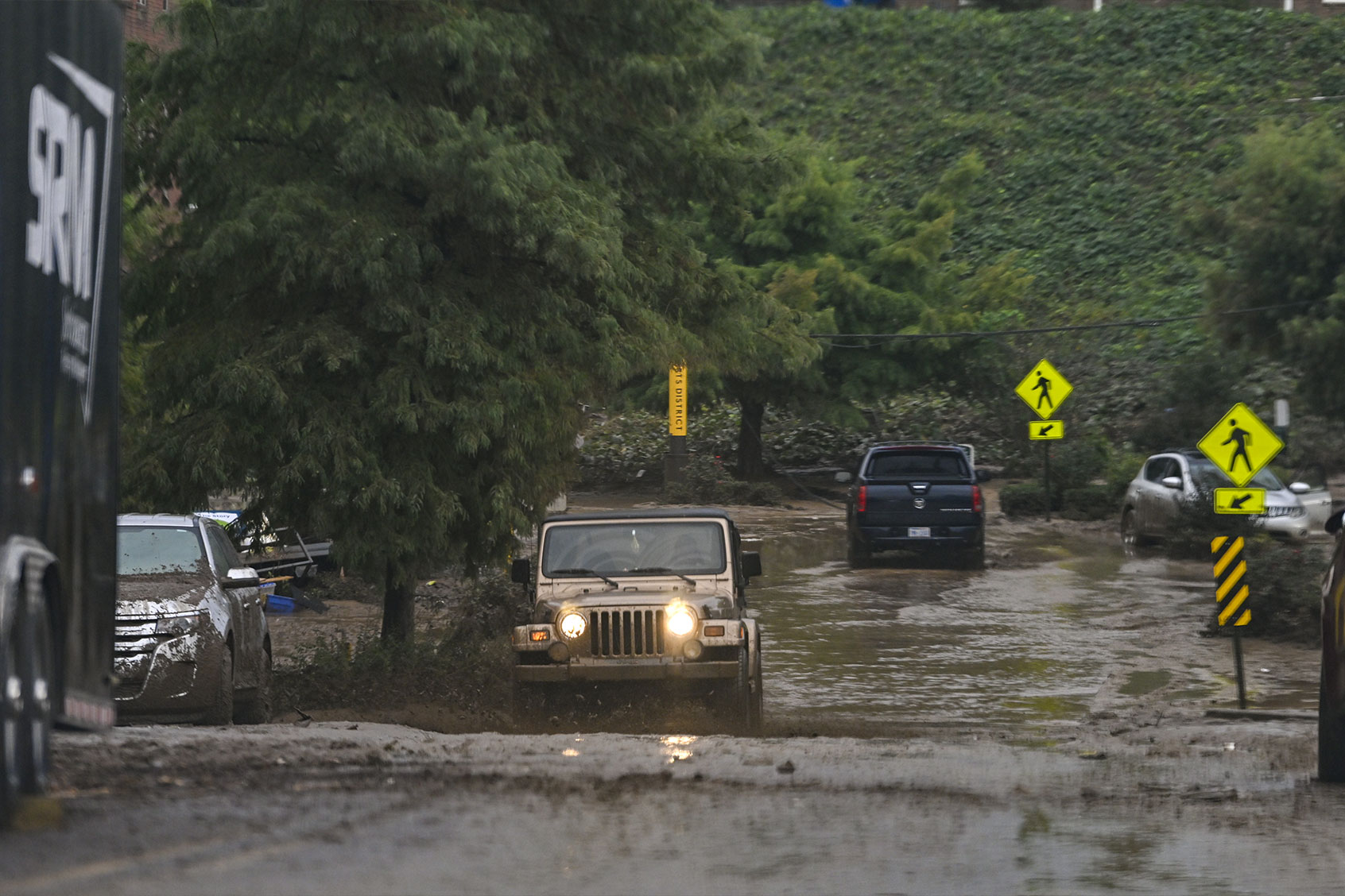 Cars pass on flooded street after hurricane Helene hits the Asheville along with the western part of North-Carolina in Asheville, United States on September 30, 2024. (Peter Zay/Anadolu via Getty Images)