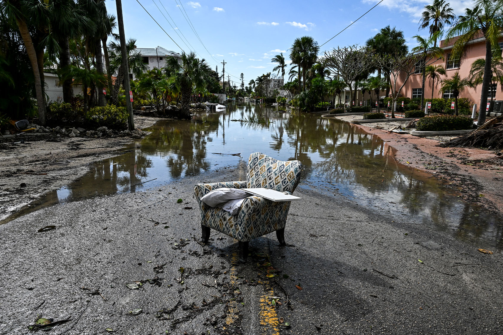 A flooded street with debris in the aftermath of Hurricane Milton, in Siesta Key, Florida, on October 10, 2024. (CHANDAN KHANNA/AFP via Getty Images)