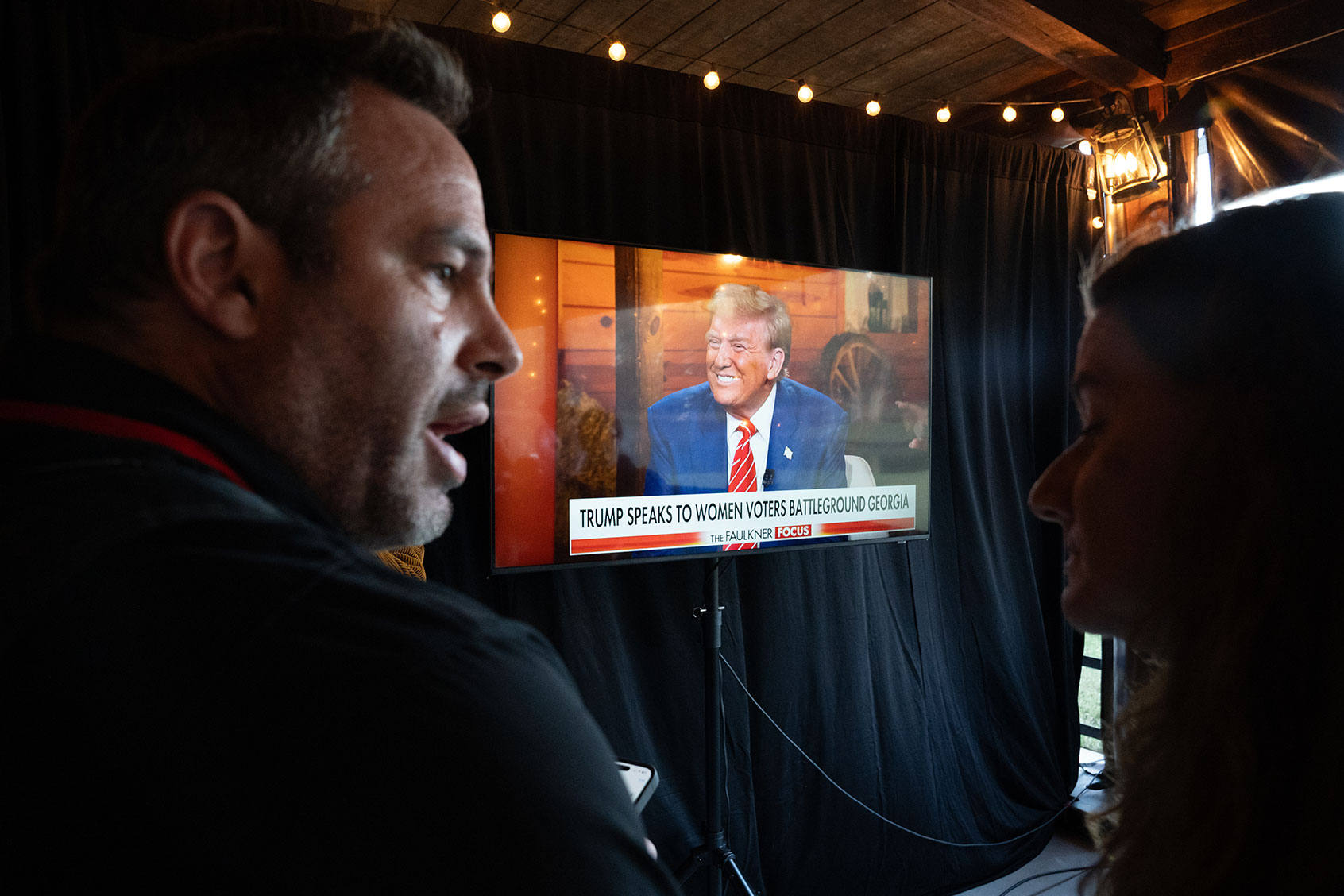 News photographers watch Republican presidential nominee, former President Donald Trump onscreen at a townhall event hosted by Fox News on October 15, 2024 in Cumming, Georgia. (Megan Varner/Getty Images)