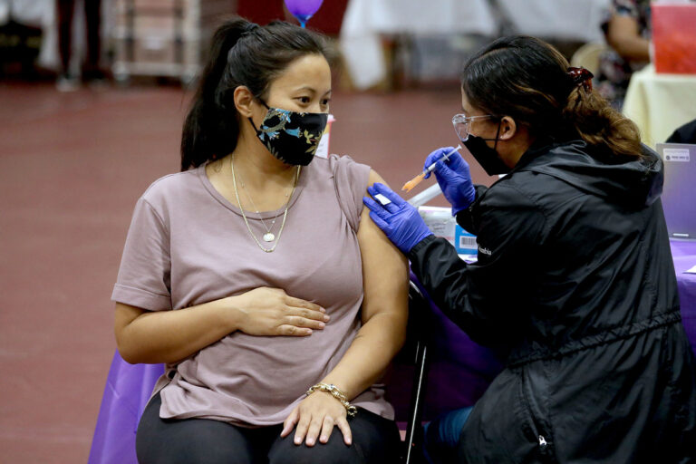 Nicole Fahey, six months pregnant, receives a Pfizer vaccination booster shot on Wednesday, Nov. 3, 2021 in Los Angeles, CA. (Gary Coronado / Los Angeles Times via Getty Images)