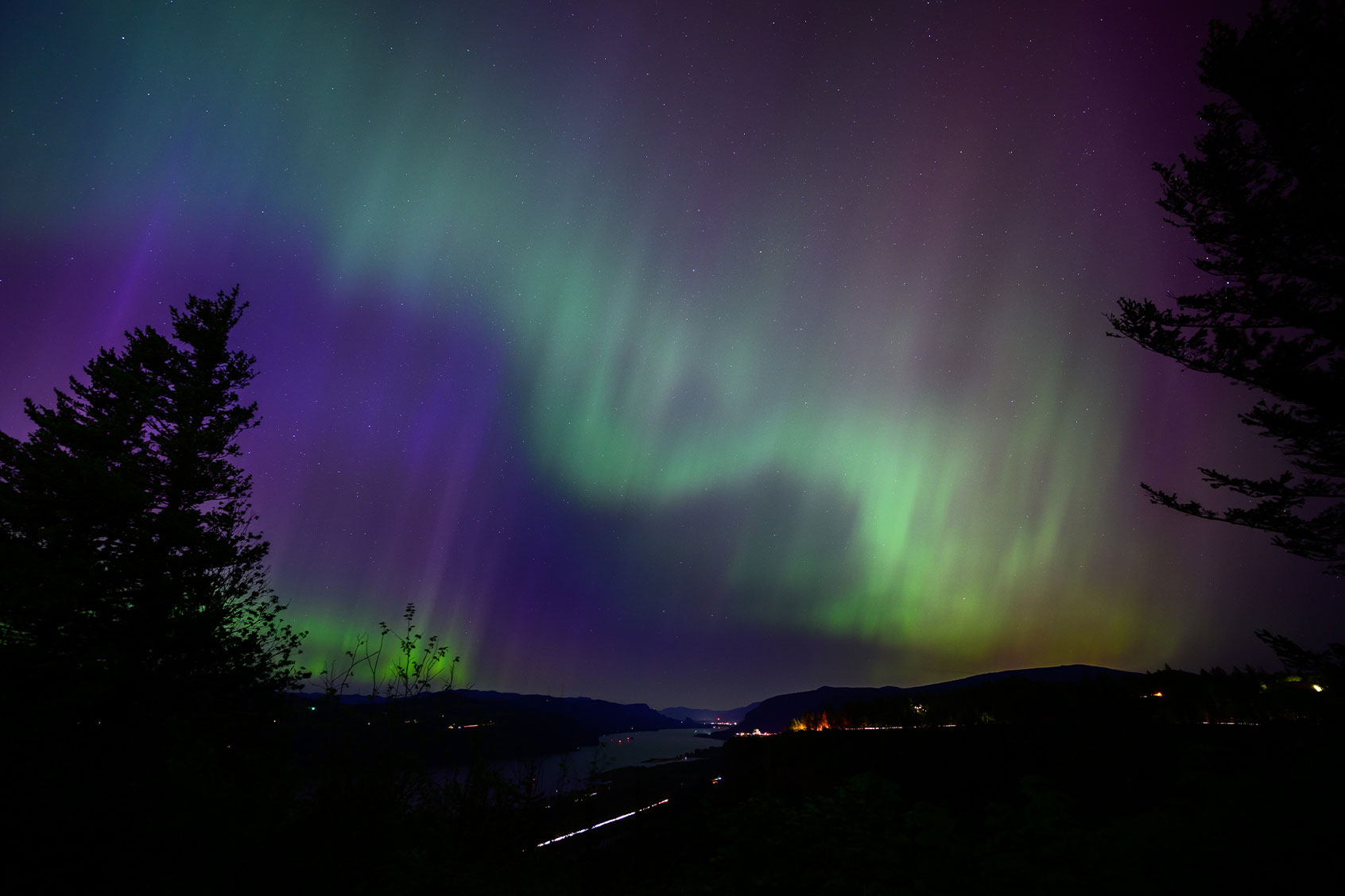 The Northern Lights are seen above the Columbia River Gorge from Chanticleer Point Lookout in the early morning hours of May 11, 2024 in Latourell, Oregon. (Mathieu Lewis-Rolland/Getty Images)