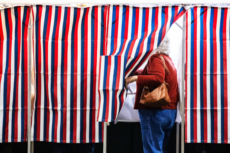 A person enters a voting booth at a polling station at Colebrook Academy and Elementary School in Colebrook, New Hampshire, on Election Day, November 5, 2024. (JOSEPH PREZIOSO/AFP via Getty Images)