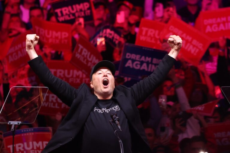 Tesla and X CEO Elon Musk raises his hands as he takes the stage during a campaign rally for Republican presidential nominee, former U.S. President Donald Trump, at Madison Square Garden on October 27, 2024 in New York City. (Michael M. Santiago/Getty Images)