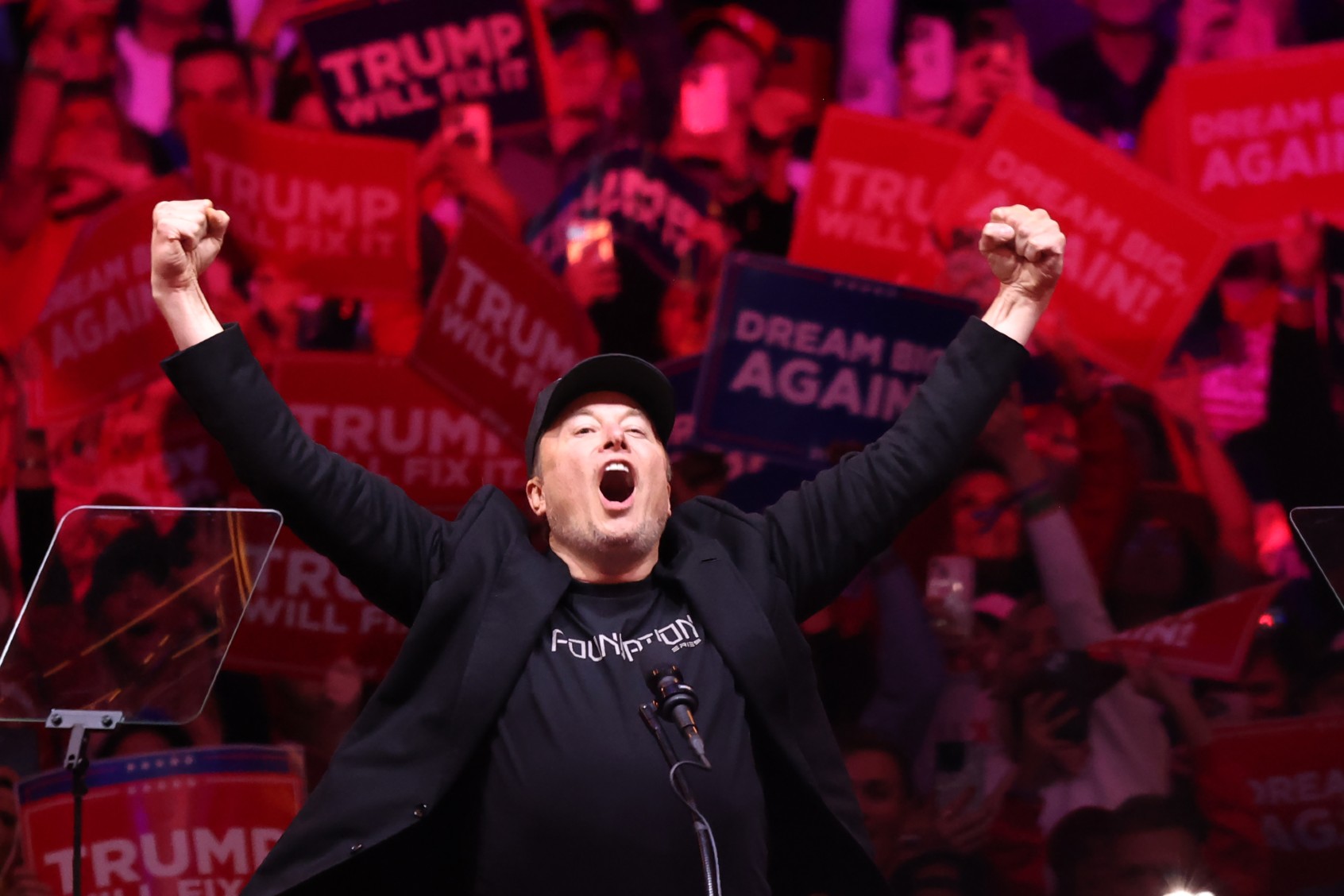 Tesla and X CEO Elon Musk raises his hands as he takes the stage during a campaign rally for Republican presidential nominee, former U.S. President Donald Trump, at Madison Square Garden on October 27, 2024 in New York City. (Michael M. Santiago/Getty Images)
