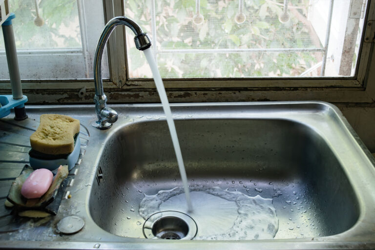 Water flow from a tap at a sink (Getty Images/Pornanun)