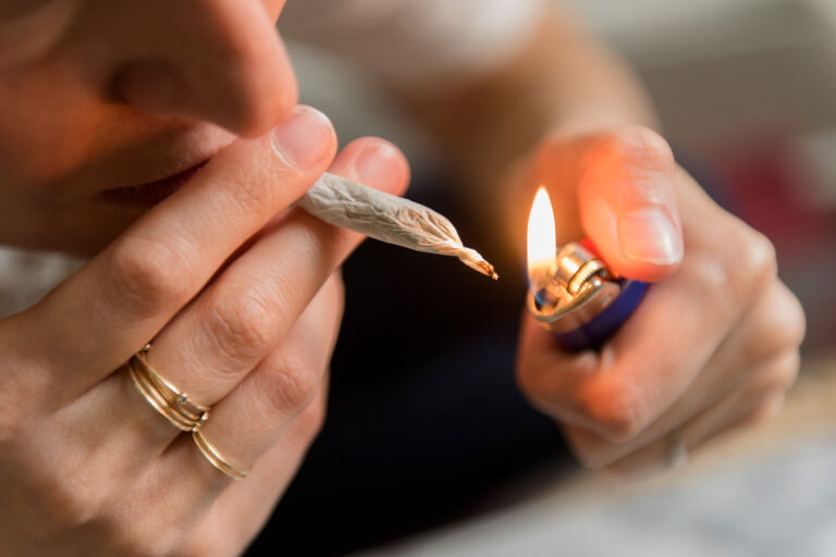 Woman lighting a marijuana joint (Getty Images/Jamie Grill)