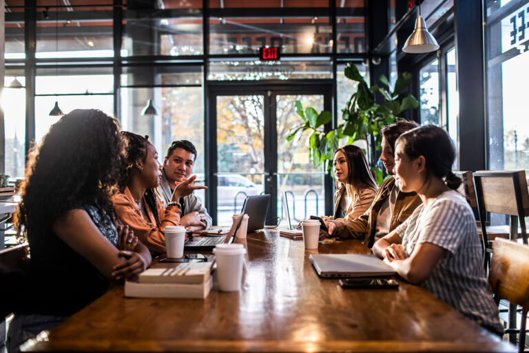Young professionals collaborating in coffeeshop (Getty Images/MoMo Productions)