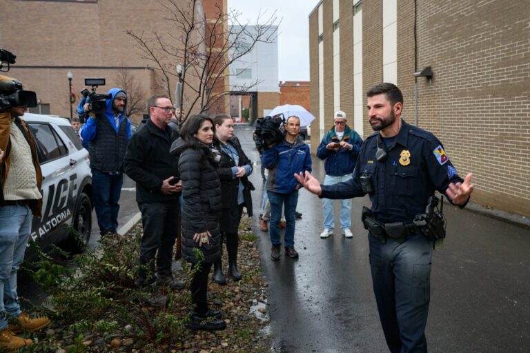 An Altoona Police officer updates members of the media outside the Altoona Police Department on December 9, 2024, in Altoona, Pennsylvania. (Jeff Swensen/Getty Images)