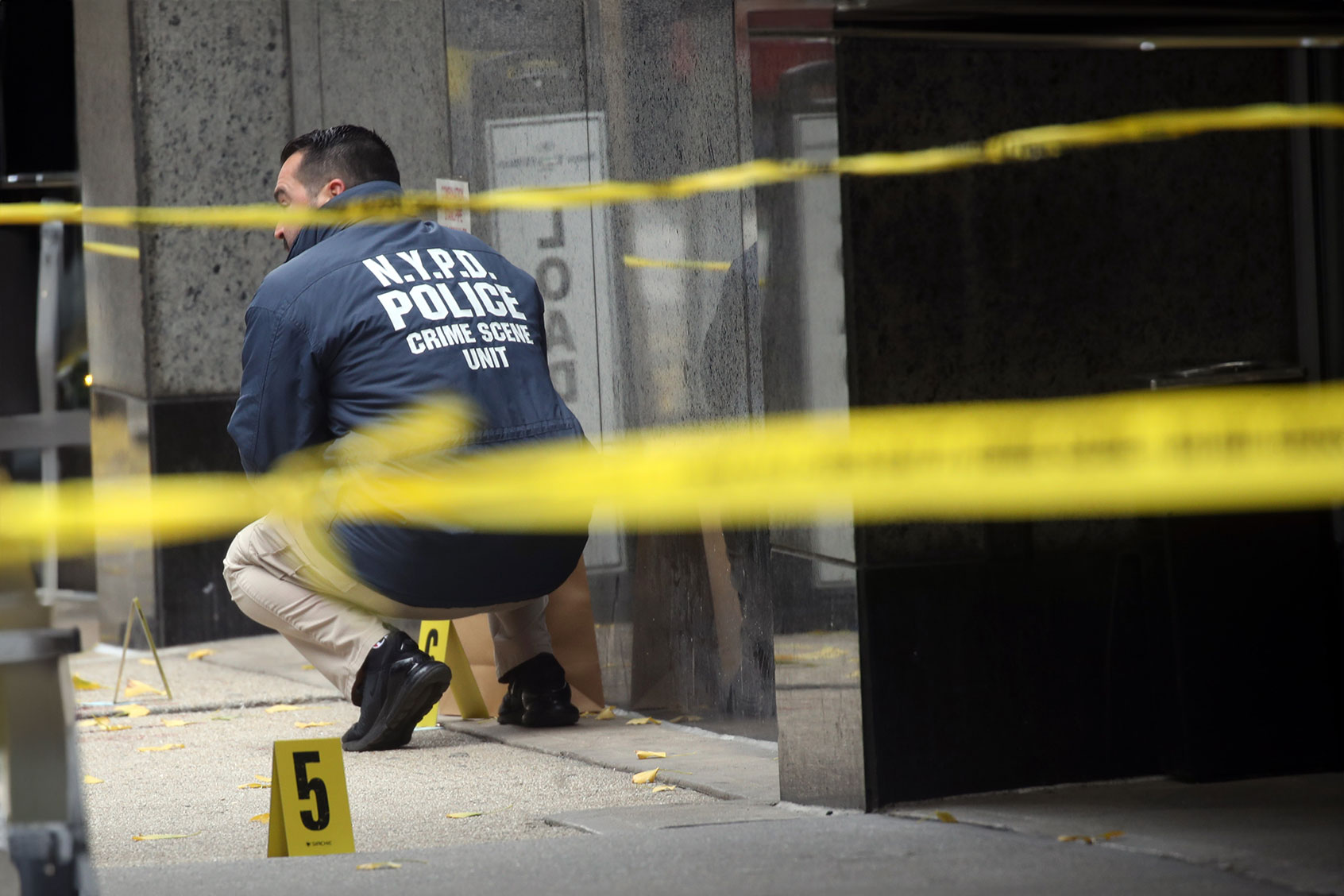Police place bullet casing markers outside of a Hilton Hotel in Midtown Manhattan where United Healthcare CEO Brian Thompson was fatally shot on December 04, 2024 in New York City. (Spencer Platt/Getty Images)