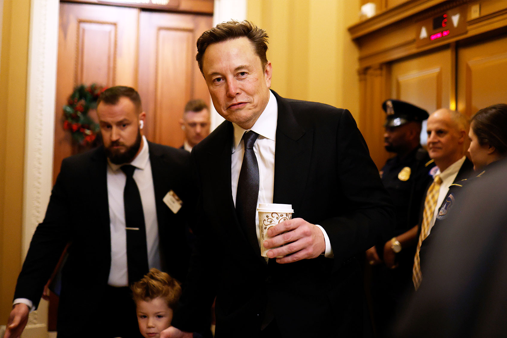 Tesla CEO Elon Musk, Co-Chair of the newly announced Department of Government Efficiency (DOGE), arrives on Capitol Hill with his son on December 05, 2024 in Washington, DC. (Anna Moneymaker/Getty Images)