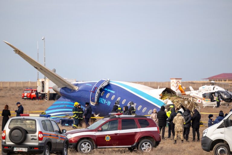 Emergency specialists work at the crash site of an Azerbaijan Airlines passenger jet near the western Kazakh city of Aktau on December 25, 2024. (Photo by ISSA TAZHENBAYEV/AFP via Getty Images)