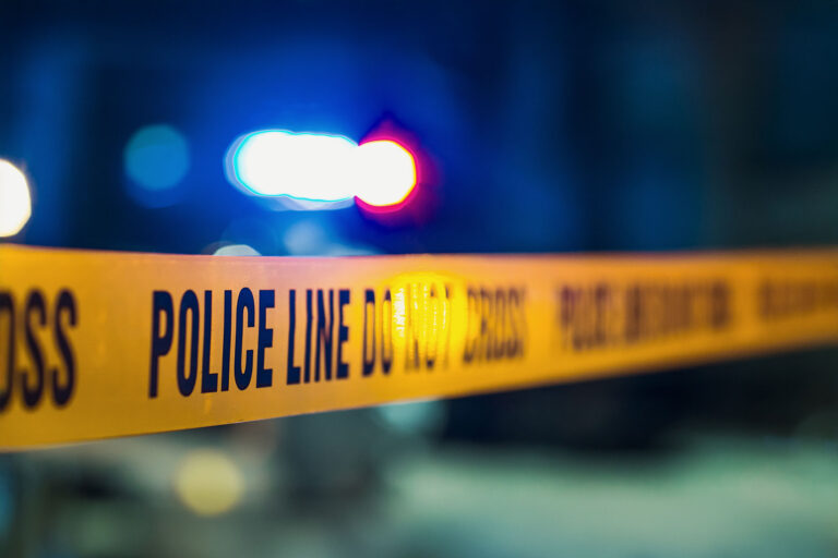 Close Up Shot Focused on Yellow Tape Showing Text Police Line Do Not Cross (Getty Images/gorodenkoff)