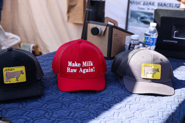A vendor sells "Make Milk Raw Again" hats at the Homesteaders of America Conference held at the Warren County Fairgrounds in Front Royal, Virginia on October 11, 2024. (Valerie Plesch for The Washington Post via Getty Images)
