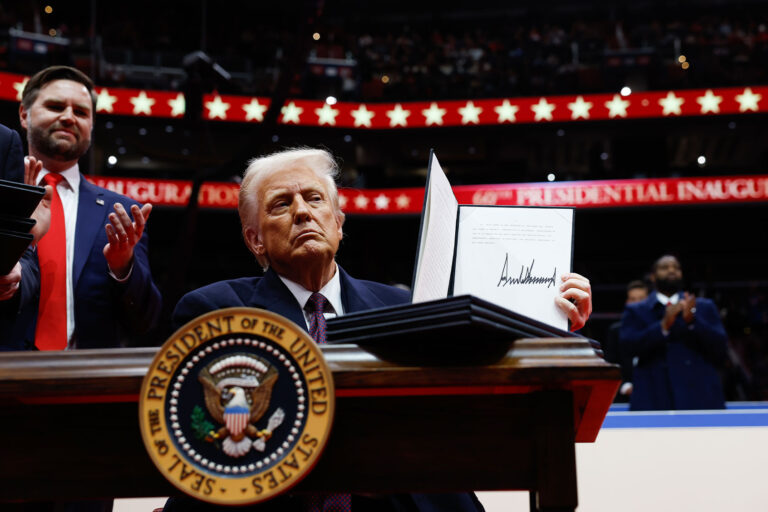 U.S. President Donald Trump holds up an executive orders after signing it during an indoor inauguration parade at Capital One Arena on January 20, 2025 in Washington, DC. (Anna Moneymaker/Getty Images)