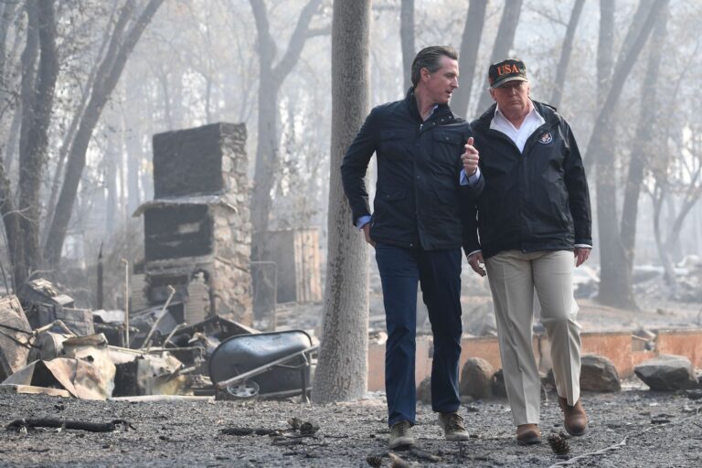 Donald Trump speaks with Gavin Newsom, as they view damage from wildfires in Paradise, California on November 17, 2018. ( Saul Loeb/AFP via Getty Images)