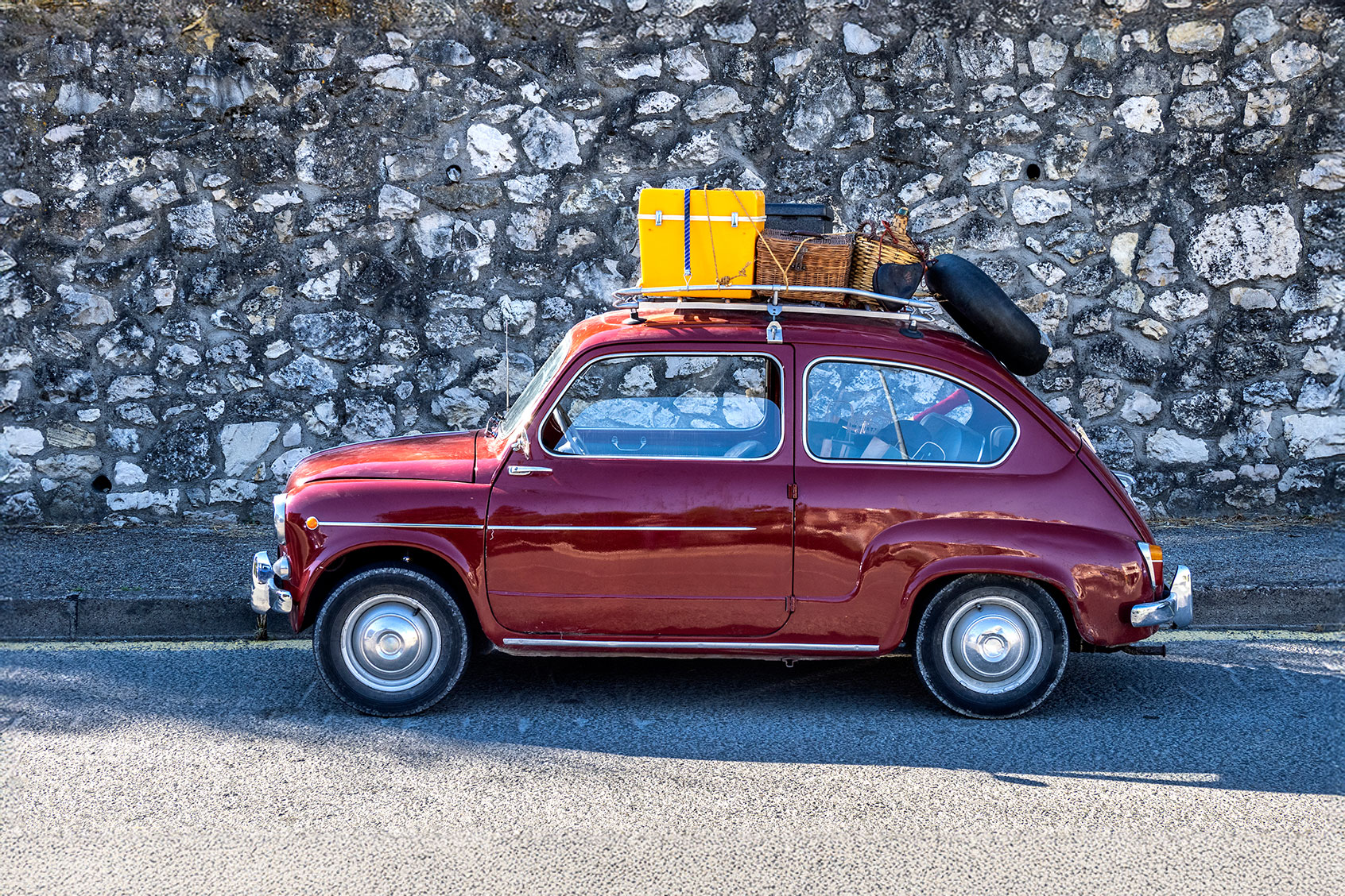 Old car loaded with suitcases (Getty Images/Jose A. Bernat Bacete)