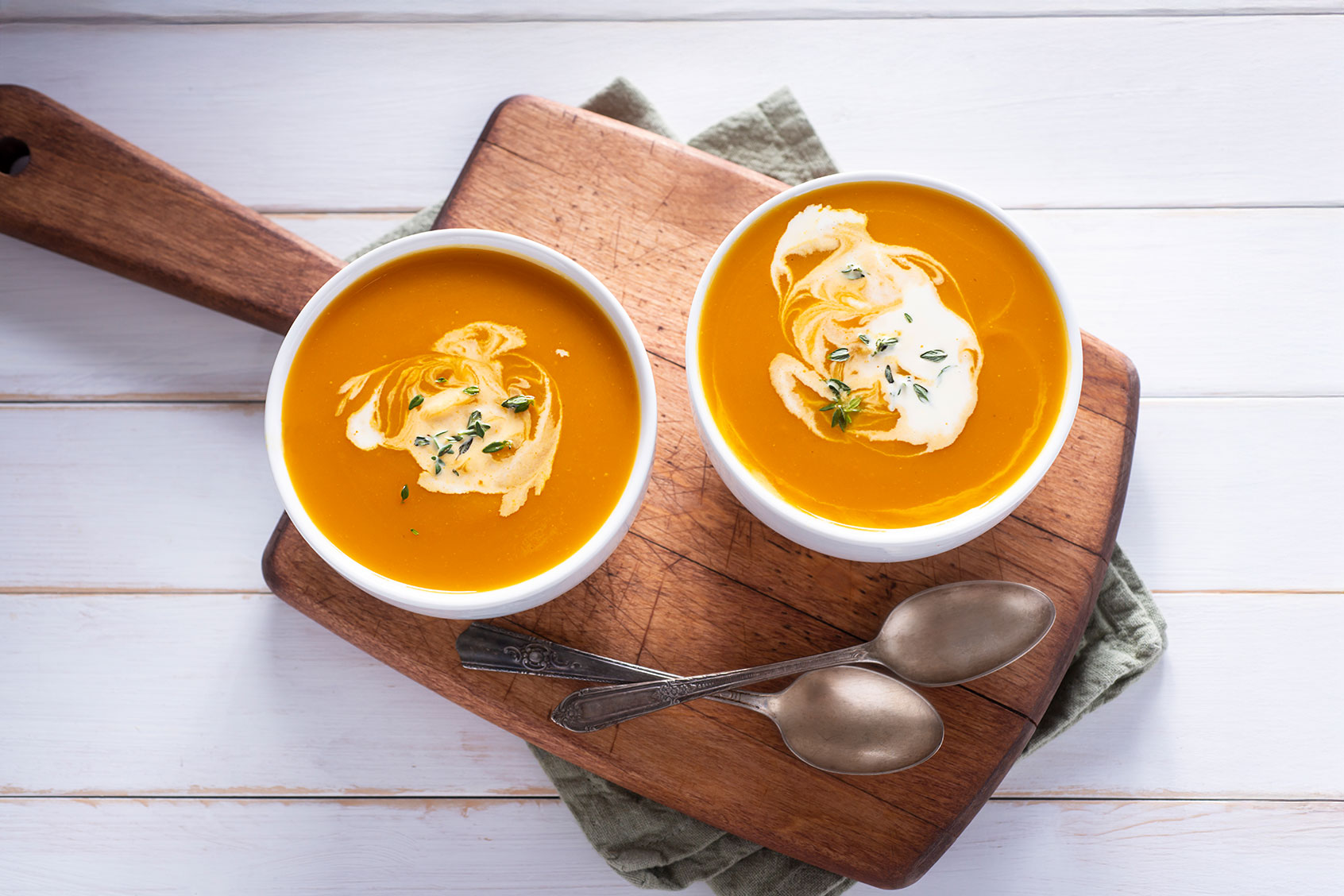 Two bowls of butternut squash soup (Getty Images/rudisill)