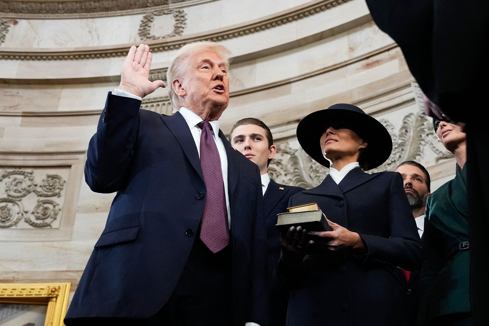 Donald Trump is sworn in as the 47th president of the United States by Chief Justice John Roberts as Melania Trump holds the Bible during the 60th Presidential Inauguration in the Rotunda of the U.S. Capitol in Washington, Monday, Jan. 20, 2025. (MORRY GASH/POOL/AFP via Getty Images)
