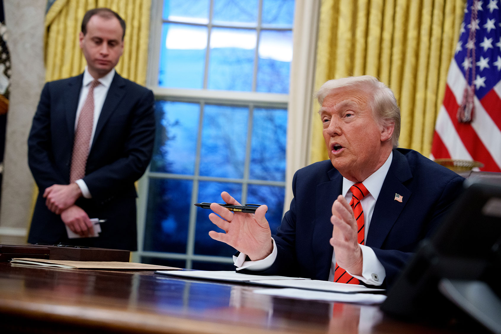 U.S. President Donald Trump, accompanied by White House staff secretary Will Scharf (L), speaks as he signs a series of executive orders in the Oval Office at the White House on February 10, 2025 in Washington, DC. (Andrew Harnik/Getty Images)