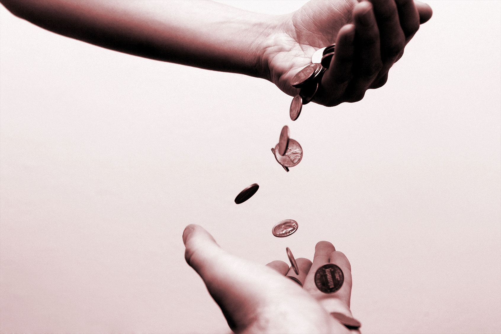 Money falling from one hand to another (Getty Images/Jitalia17)