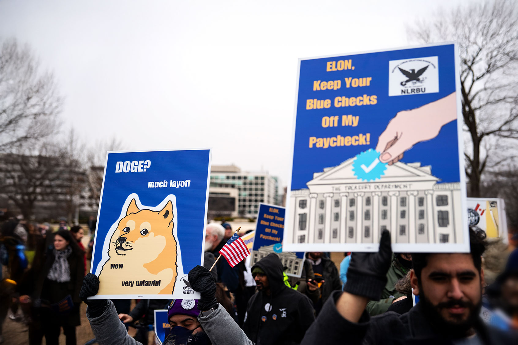 People hold signs during a "Save the Civil Service" rally hosted by the American Federation of Government Employees (AFGE) outside the U.S. Capitol on February 11, 2025 in Washington, DC. (Kent Nishimura/Getty Images)