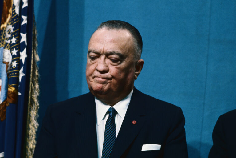 FBI Director J. Edgar Hoover listens to a speech by President Lyndon Johnson, 1966. (Bettman/Getty Images)