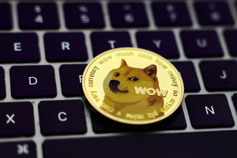 A laptop keyboard and representation of Dogecoin cryptocurrency (Jakub Porzycki/NurPhoto via Getty Images)