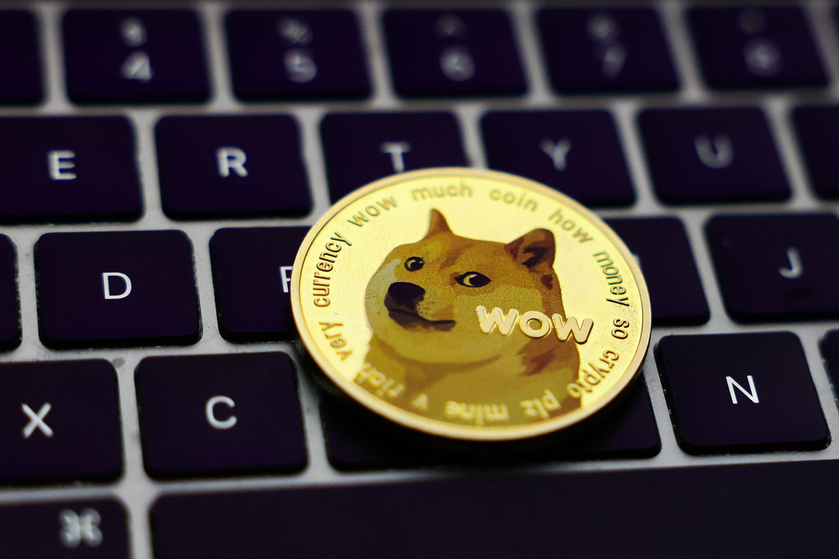 A laptop keyboard and representation of Dogecoin cryptocurrency (Jakub Porzycki/NurPhoto via Getty Images)