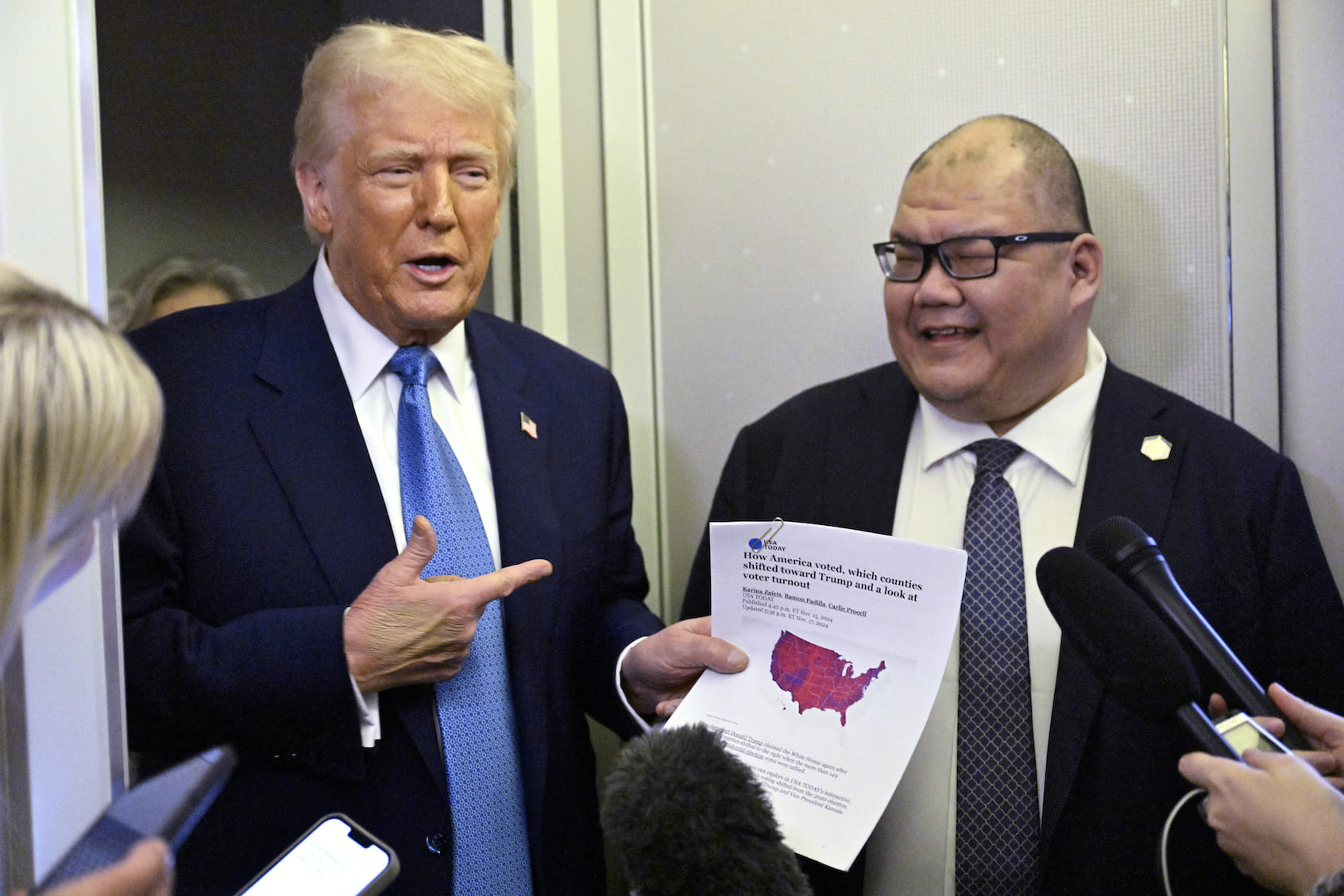 US President Donald Trump speaks with journalist, alongside White House Communications Director Steven Cheung (R), on board Air Force One on route from Miami, Florida, to the White House in Washington, DC on February 19, 2025. (Photo by Roberto Schmidt/Getty Images)