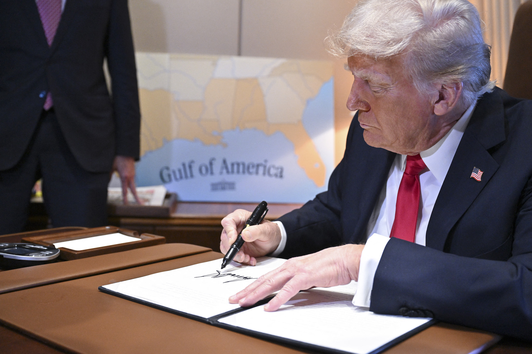 US President Donald Trump signs a proclamation renaming the Gulf of Mexico as the Gulf of America aboard Air Force One, enroute to New Orleans, Louisiana on Febrary 09, 2025. (Photo by Roberto Schmidt/Getty Images)