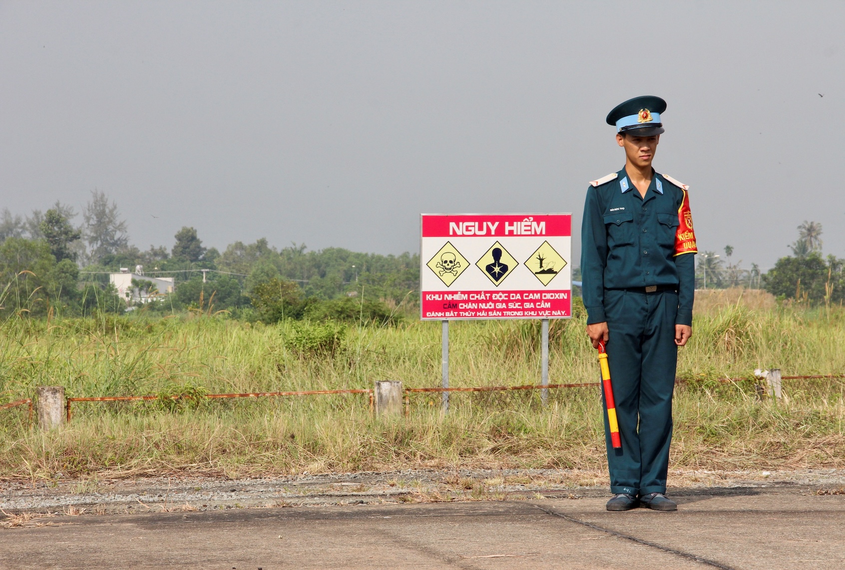 A Vietnamese soldier stands next to a hazardous warning sign by a runway at Bien Hoa air base, on the outskirts of Ho Chi Minh City, as US Defence Secretary Jim Mattis visits the former US air base on October 17, 2018. - The toxic legacy of the Vietnam War came under the spotlight again on October 17 when Mattis visits a former storage site for Agent Orange, which is blamed for birth defects and cancers among a million Vietnamese. (THOMAS WATKINS/AFP via Getty Images)