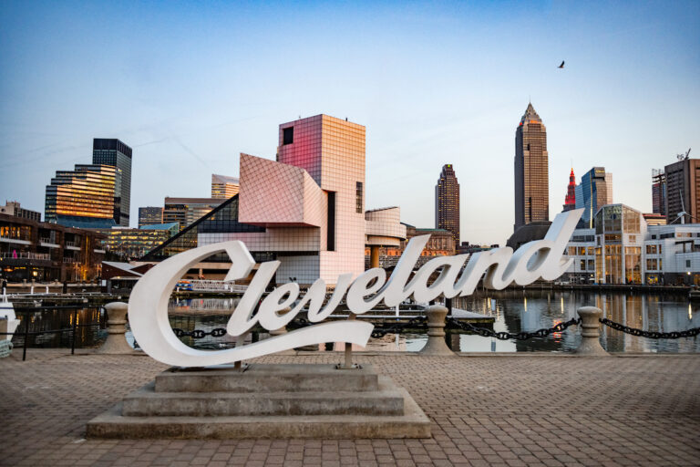 In Ohio, the Cleveland script sign is placed in front of the cityscape with the Rock and Roll Hall of Fame building. (Getty Image/	Boogich)