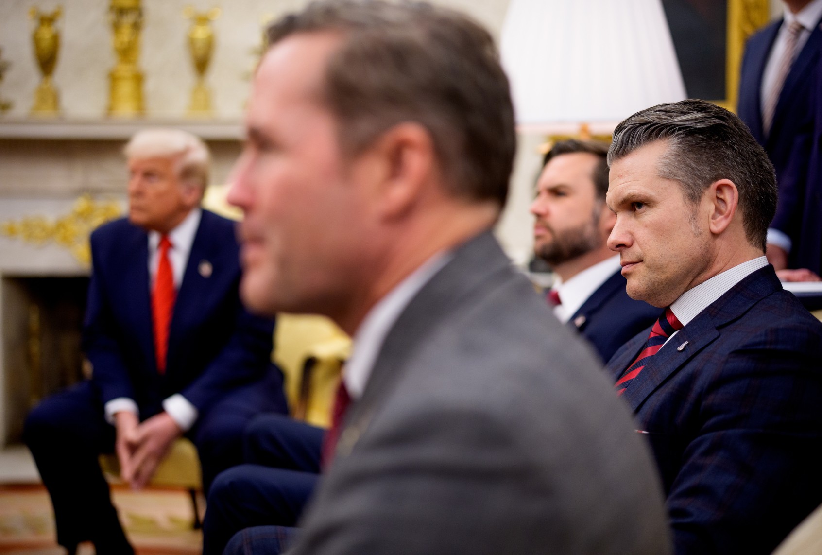 U.S. President Donald Trump, U.S. National Security Adviser Michael Waltz, U.S. Vice President J.D. Vance, and Defense Secretary Pete Hegseth, listen to a question from a reporter during a meeting in the Oval Office of the White House on March 13, 2025 in Washington, DC. (Andrew Harnik/Getty Images)